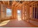 Unfinished interior shows framing, window placement, and a glimpse of the outdoor view, during construction at 217 Pond Vw Ct # 7, Fuquay Varina, NC 27526