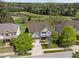 Beautiful traditional-style home with a well-manicured lawn, mature trees, and a serene pond in the backyard at 224 Clear River Pl, Cary, NC 27519