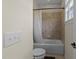 Cozy bathroom featuring a tiled shower with a white shower curtain and neutral color palette at 224 Clear River Pl, Cary, NC 27519