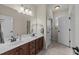 Bathroom featuring a double sink vanity, neutral color scheme, and ample lighting at 224 Clear River Pl, Cary, NC 27519
