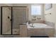 Luxurious primary bathroom with a separate shower and a soaking tub with tile surround at 224 Clear River Pl, Cary, NC 27519