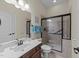 Bathroom featuring a glass enclosed shower, vanity with dark wood cabinetry, and neutral color scheme at 224 Clear River Pl, Cary, NC 27519