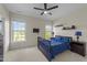 Bright bedroom with natural light from two windows, ceiling fan, and carpeted floors at 224 Clear River Pl, Cary, NC 27519
