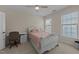 Bedroom features a bed, ample natural light from two windows, a ceiling fan, and a desk at 224 Clear River Pl, Cary, NC 27519