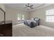 Bright primary bedroom with a tray ceiling, a ceiling fan, and French doors to the deck at 224 Clear River Pl, Cary, NC 27519