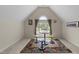 Bright bonus room with decorative rug, window, and bar stools, offering a cozy area at 224 Clear River Pl, Cary, NC 27519