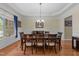 Elegant dining room features hardwood floors, trey ceiling, crown molding, and ample natural light at 224 Clear River Pl, Cary, NC 27519