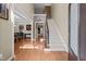 Inviting foyer with hardwood floors, a staircase, and views into the living and dining rooms at 224 Clear River Pl, Cary, NC 27519