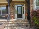 Stunning stone front with a covered porch and elegant glass front door at 224 Clear River Pl, Cary, NC 27519