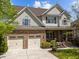 Charming home with a two-car garage, stone accents, and a welcoming front porch at 224 Clear River Pl, Cary, NC 27519