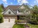Lovely two-story home featuring stone accents, a two-car garage, and landscaped front yard at 224 Clear River Pl, Cary, NC 27519