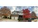 Beautiful two-story home with stone accents, mature trees, and well-maintained landscaping enhancing its curb appeal at 224 Clear River Pl, Cary, NC 27519