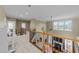 Bright upper hallway featuring decorative banisters, a grand view of the living room, and a piano at 224 Clear River Pl, Cary, NC 27519