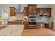 Gourmet kitchen with stainless appliances, granite countertops, and custom cabinetry at 224 Clear River Pl, Cary, NC 27519