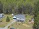 Lovely two-story home with mature trees, lush landscaping, and long driveway provides ample parking at 230 Bradley Dr, Benson, NC 27504