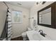 Cozy bathroom with white vanity, bamboo mirror, and shower-tub combo at 230 Bradley Dr, Benson, NC 27504