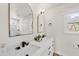 Bright bathroom with dual sinks, modern fixtures, and a view of the garden at 230 Bradley Dr, Benson, NC 27504