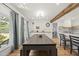 Open dining area featuring modern lighting and a large table with seating, adjacent to a kitchen at 230 Bradley Dr, Benson, NC 27504