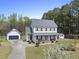 Charming two-story home with well-manicured lawn, mature trees, and a detached garage at 230 Bradley Dr, Benson, NC 27504