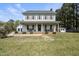 Traditional two-story home with a welcoming front porch and neatly maintained landscaping at 230 Bradley Dr, Benson, NC 27504