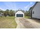 Detached garage with a dark garage door and concrete driveway on a sunny day at 230 Bradley Dr, Benson, NC 27504