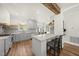 Well-lit kitchen with island seating, floating shelves, and stainless steel appliances at 230 Bradley Dr, Benson, NC 27504