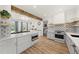 Bright kitchen with a large island, stylish backsplash, stainless steel appliances, and open layout at 230 Bradley Dr, Benson, NC 27504
