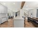 Open-concept kitchen featuring island seating, modern appliances, and easy access to the staircase at 230 Bradley Dr, Benson, NC 27504
