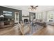 Cozy living room featuring a stone fireplace, neutral color palette, and hardwood floors at 230 Bradley Dr, Benson, NC 27504
