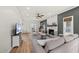 Open-concept living room with a stone fireplace and view to a dining area with ample natural light at 230 Bradley Dr, Benson, NC 27504
