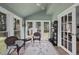 Bright sunroom featuring a vaulted ceiling, many windows, and views of the backyard at 230 Bradley Dr, Benson, NC 27504