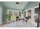 Bright sunroom featuring a vaulted ceiling, many windows, and views of the backyard at 230 Bradley Dr, Benson, NC 27504
