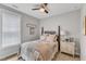 Cozy bedroom features a four-poster bed with floral bedding, a ceiling fan, and a decorative nightstand at 2321 Swansea Ln, Apex, NC 27502