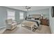 A beautifully designed bedroom with a tufted headboard, ceiling fan, and neutral color palette at 2321 Swansea Ln, Apex, NC 27502