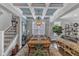 Elegant dining room featuring a coffered ceiling, a stylish chandelier, and ample natural light at 2321 Swansea Ln, Apex, NC 27502