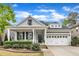 Charming home featuring a covered porch with white columns and manicured landscaping at 2321 Swansea Ln, Apex, NC 27502