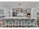 Spacious kitchen showcasing a large island with seating, stainless steel appliances, and modern lighting at 2321 Swansea Ln, Apex, NC 27502