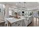 Open concept kitchen island featuring stainless steel sink and pendant lighting at 2321 Swansea Ln, Apex, NC 27502
