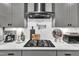 Modern kitchen design featuring stainless steel range hood and tiled backsplash at 2321 Swansea Ln, Apex, NC 27502