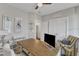 Functional office space featuring a ceiling fan, closet, a work desk, and a comfortable accent chair at 2321 Swansea Ln, Apex, NC 27502