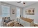 Inviting office space featuring a ceiling fan, large windows, a desk and a comfortable accent chair at 2321 Swansea Ln, Apex, NC 27502