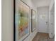 Inviting entryway featuring beautiful art, luxury vinyl plank flooring and natural light from the front door at 25 Granite Falls Way, Youngsville, NC 27596