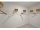 Walk-in closet with multiple shelves and hanging rods at 25 Granite Falls Way, Youngsville, NC 27596
