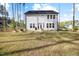 The back of this two-story home has a nice backyard with tall trees at 254 W Odell Ln, Zebulon, NC 27597
