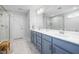 Bright bathroom featuring a glass enclosed shower, double sink vanity, and marble countertops at 254 W Odell Ln, Zebulon, NC 27597