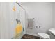 Bathroom with a shower featuring a decorative animal-themed curtain, enhancing a playful aesthetic at 254 W Odell Ln, Zebulon, NC 27597