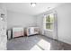 Bright Bedroom with a wooden crib and changing table, complemented by natural light from a window at 254 W Odell Ln, Zebulon, NC 27597