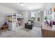 Bright bedroom featuring a lofted bed and comfortable reading nook with a soft leather chair at 254 W Odell Ln, Zebulon, NC 27597