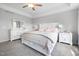 Well-lit bedroom featuring neutral decor, tray ceilings, and ample space with a large bed at 254 W Odell Ln, Zebulon, NC 27597