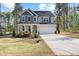 Inviting two-story home with a covered porch, a two-car garage, and complemented by lush landscaping at 254 W Odell Ln, Zebulon, NC 27597